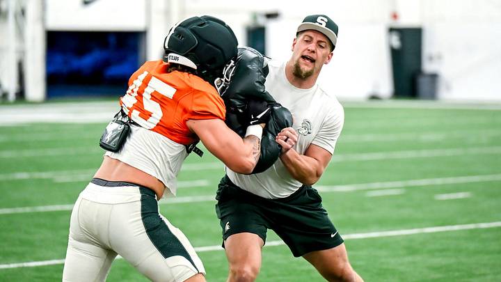 Michigan State's co-defensive coordinator/linebackers coach Max Bullough, right, works with Brady Pretzlaff during spring football practice on Tuesday, April 14, 2026, in East Lansing. Michigan State's co-defensive coordinator/linebackers coach Max Bullough, right, works with Brady Pretzlaff during spring football practice on Tuesday, April 14, 2026, in East Lansing.