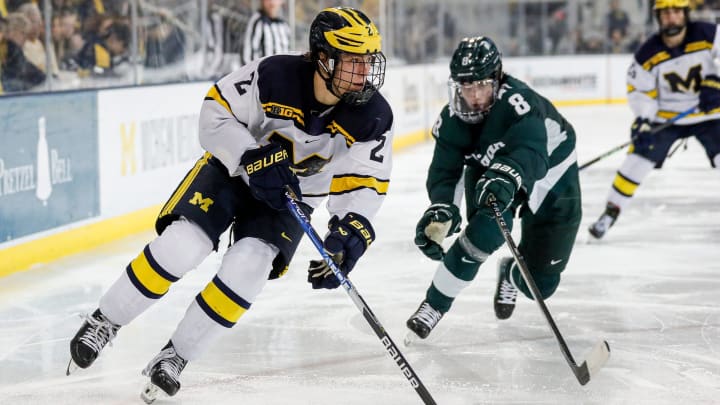 Michigan left wing Rutger McGroarty looks to pass against Michigan State defenseman Maxim Strbak during the third period at Yost Ice Arena in Ann Arbor on Friday, Feb. 9, 2024.
