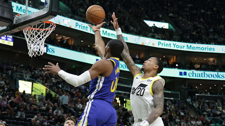Feb 15, 2024; Salt Lake City, Utah, USA; Golden State Warriors forward Jonathan Kuminga (00) gets past Utah Jazz forward John Collins (20) and shoots during the second half at Delta Center. Mandatory Credit: Chris Nicoll-Imagn Images