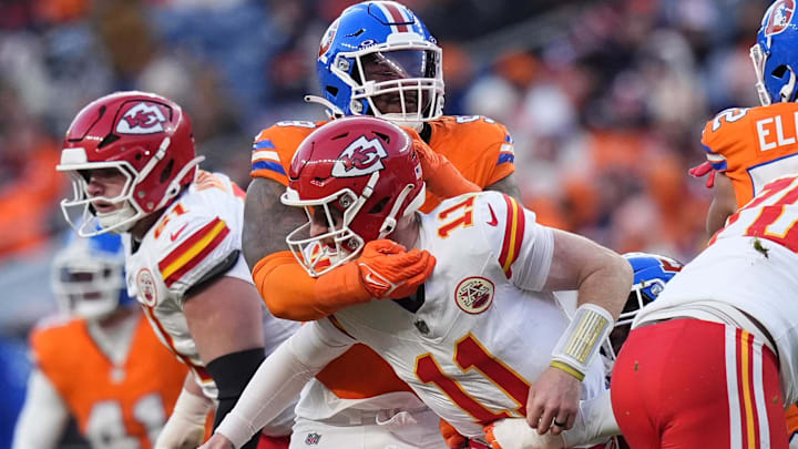 Jan 5, 2025; Denver, Colorado, USA; Denver Broncos defensive end John Franklin-Myers (98) hits Kansas City Chiefs quarterback Carson Wentz (11) in the second half at Empower Field at Mile High. Mandatory Credit: Ron Chenoy-Imagn Images