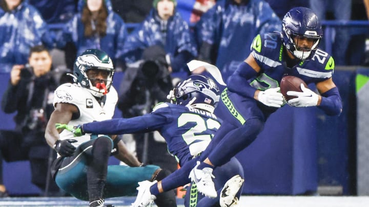Dec 18, 2023; Seattle, Washington, USA; Seattle Seahawks safety Julian Love (20) intercepts a pass against the Philadelphia Eagles during the fourth quarter at Lumen Field. Mandatory Credit: Joe Nicholson-USA TODAY Sports