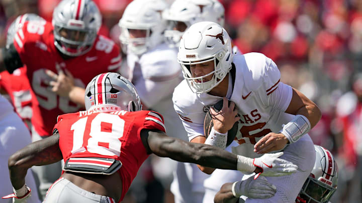 Ohio State Buckeyes safety Jaylen McClain tries to tackle Texas Longhorns quarterback Arch Manning.