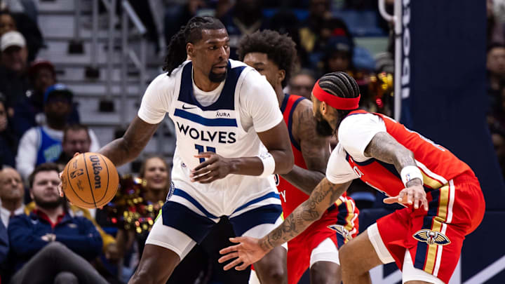 Dec 11, 2023; New Orleans, Louisiana, USA; Minnesota Timberwolves center Naz Reid (11) dribbles against New Orleans Pelicans forward Brandon Ingram (14) during the second half at the Smoothie King Center. Mandatory Credit: Stephen Lew-USA TODAY Sports
