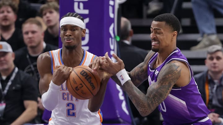 Jan 18, 2024; Salt Lake City, Utah, USA;  Oklahoma City Thunder guard Shai Gilgeous-Alexander (2) and Utah Jazz forward John Collins (20) fight for the ball during the first quarter at Delta Center. Mandatory Credit: Chris Nicoll-Imagn Images