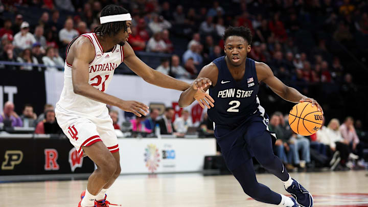 Penn State Nittany Lions guard D'Marco Dunn (2) dribbles around Indiana Hoosiers forward Mackenzie Mgbako (21) during the second half of a Big Ten Tournament game at Target Center in March 2024.  Both players are still contributing to their respective teams.