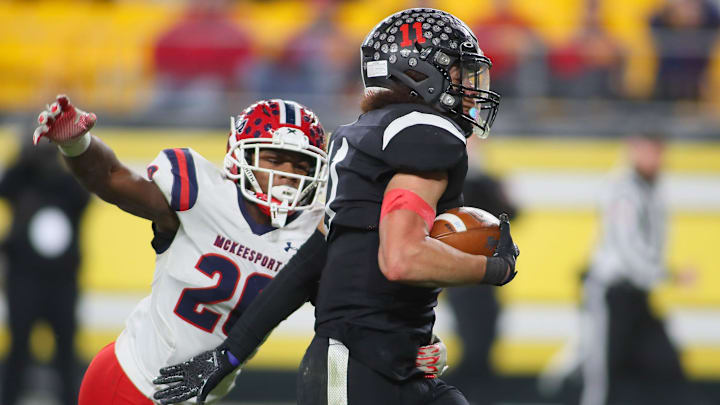 Aliquippa's Cameron Lindsey (11) pushes away from McKeesport's Kemon Spell (20) during the first half of the WPIAL 4A Championship game Friday evening at Acrisure Stadium in Pittsburgh, PA. Aliquippa's Cameron Lindsey (11) pushes away from McKeesport's Kemon Spell (20) during the first half of the WPIAL 4A Championship game Friday evening at Acrisure Stadium in Pittsburgh, PA.