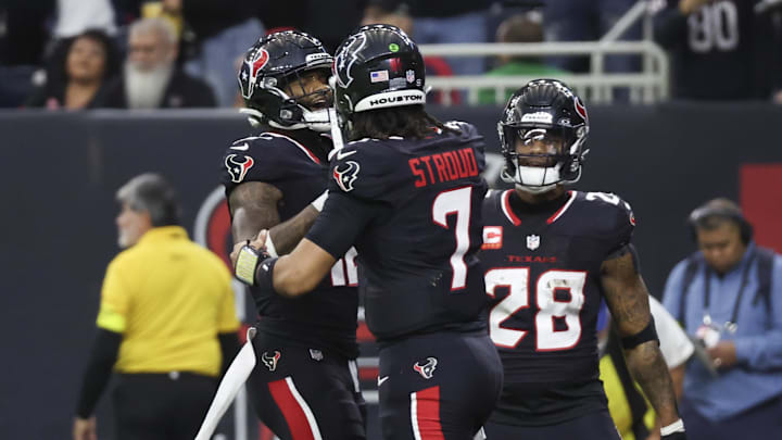 Jan 11, 2025; Houston, Texas, USA;  Houston Texans quarterback C.J. Stroud (7) celebrates wide receiver Nico Collins (12) touchdown against the Los Angeles Chargers in the second quarter in an AFC wild card game at NRG Stadium.