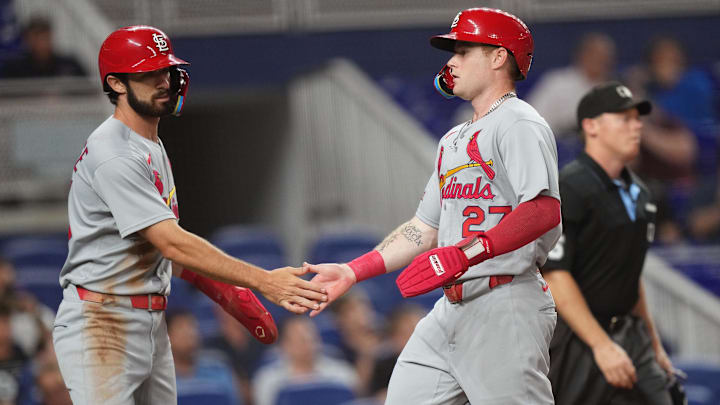 Aug 19, 2025; Miami, Florida, USA;  St. Louis Cardinals second baseman Thomas Saggese (25) congratulates center fielder Nathan Church (27) on scoring a run in the second inning against the Miami Marlins at loanDepot Park. Mandatory Credit: Jim Rassol-Imagn Images