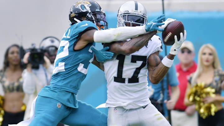 Las Vegas Raiders wide receiver Davante Adams (17) pulls in a first quarter touchdown pass while being defended by Jacksonville Jaguars cornerback Tyson Campbell (32). The Jacksonville Jaguars hosted the Las Vegas Raiders at TIAA Bank Field in Jacksonville, FL Sunday November 6, 2022. The Jaguars trailed 20 to 10 at the end of the first half. [Bob Self/Florida Times-Union]

Jki 110622 Bs Jaguars Vs R 2