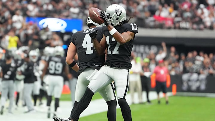 Sep 18, 2022; Paradise, Nevada, USA; Las Vegas Raiders wide receiver Davante Adams (17) celebrates with Las Vegas Raiders quarterback Derek Carr (4) after scoring a touchdown against the Arizona Cardinals at Allegiant Stadium. Mandatory Credit: Stephen R. Sylvanie-Imagn Images