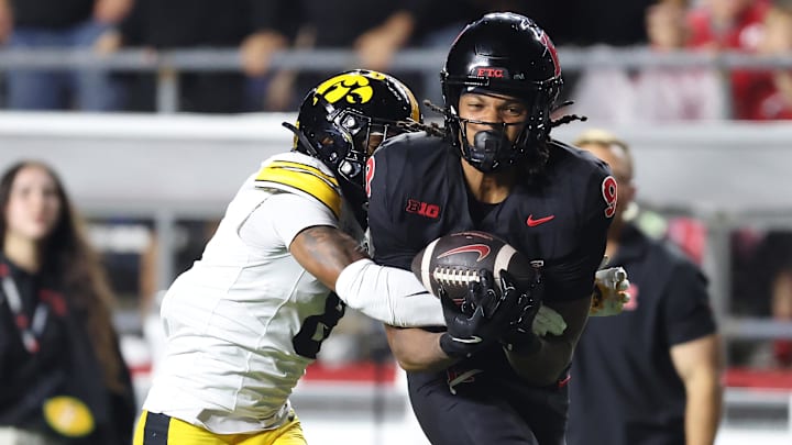 Sep 19, 2025; Piscataway, New Jersey, USA; Rutgers Scarlet Knights wide receiver Ian Strong (9) makes a catch as Iowa Hawkeyes defensive back Deshaun Lee (8) defends during the second half at SHI Stadium. Mandatory Credit: Vincent Carchietta-Imagn Images