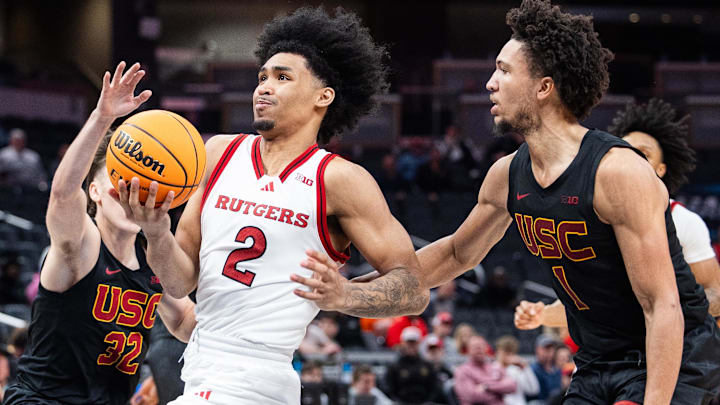 Mar 12, 2025; Indianapolis, IN, USA;  Rutgers Scarlet Knights guard Dylan Harper (2) shoots the ball while USC Trojans guard Desmond Claude (1) defends in the second half at Gainbridge Fieldhouse. Mandatory Credit: Trevor Ruszkowski-Imagn Images