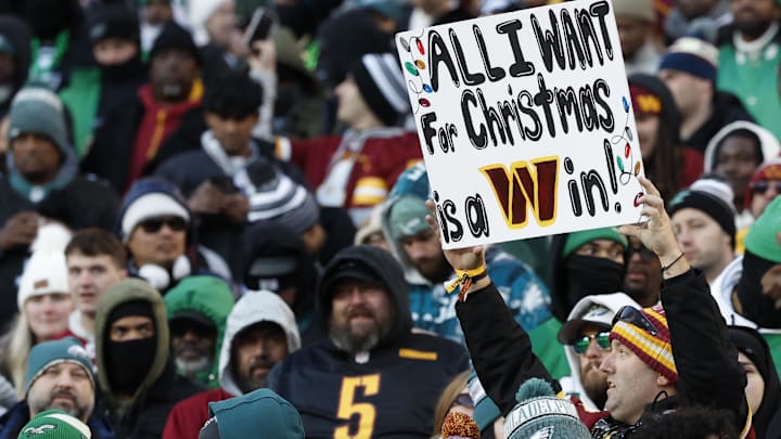 Dec 22, 2024; Landover, Maryland, USA; A fan holds a sign in the stands during the game between the Washington Commanders and Philadelphia Eagles during the third quarter at Northwest Stadium. Mandatory Credit: Geoff Burke-Imagn Images Dec 22, 2024; Landover, Maryland, USA; A fan holds a sign in the stands during the game between the Washington Commanders and Philadelphia Eagles during the third quarter at Northwest Stadium. Mandatory Credit: Geoff Burke-Imagn Images