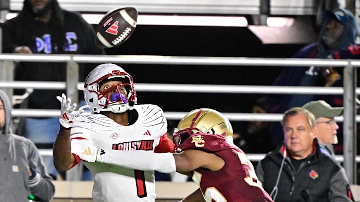 Oct 25, 2024; Chestnut Hill, Massachusetts, USA; Louisville Cardinals wide receiver Ja'Corey Brooks (1) makes a catch while being defended by Boston College Eagles defensive back Ashton McShane (35) during the second half at Alumni Stadium. Mandatory Credit: Eric Canha-Imagn Images
