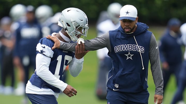 May 1, 2026; Frisco, TX, USA;  Dallas Cowboys cornerback Caleb Downs (18) is coached through a drill with defensive coordinator Christian Parker at the Ford Center at the Star Training Facility in Frisco, Texas.  Mandatory Credit: Chris Jones-Imagn Images