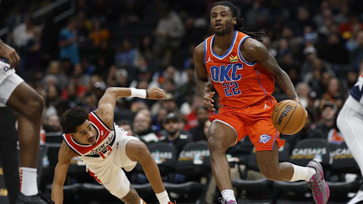Jan 12, 2025; Washington, District of Columbia, USA; Oklahoma City Thunder guard Cason Wallace (22) drives to the basket past Washington Wizards guard Jordan Poole (13) in the third quarter at Capital One Arena. Mandatory Credit: Geoff Burke-Imagn Images