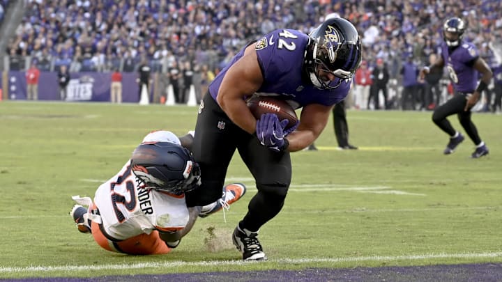 Nov 3, 2024; Baltimore, Maryland, USA; Baltimore Ravens fullback Patrick Ricard (42) dives through Denver Broncos linebacker Kwon Alexander (12) tackle attempt for a touchdown during the second half at M&T Bank Stadium. Mandatory Credit: Tommy Gilligan-Imagn Images Nov 3, 2024; Baltimore, Maryland, USA; Baltimore Ravens fullback Patrick Ricard (42) dives through Denver Broncos linebacker Kwon Alexander (12) tackle attempt for a touchdown during the second half at M&T Bank Stadium. Mandatory Credit: Tommy Gilligan-Imagn Images