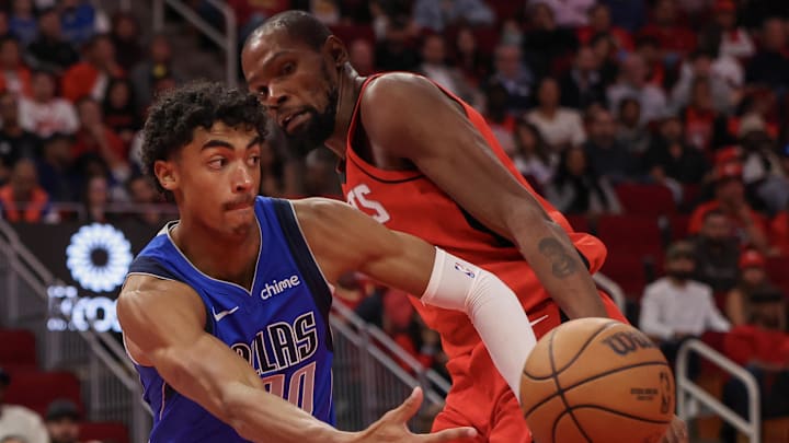 Nov 3, 2025; Houston, Texas, USA; Dallas Mavericks guard Max Christie (00) passes against Houston Rockets forward Kevin Durant (7)  in the fourth quarter at Toyota Center. Mandatory Credit: Thomas Shea-Imagn Images