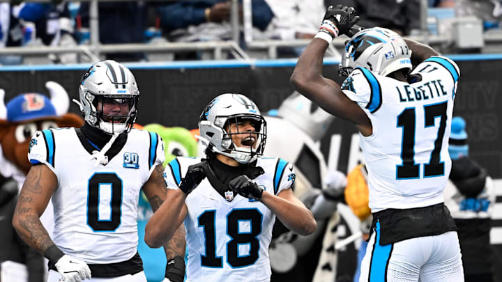 Dec 15, 2024; Charlotte, North Carolina, USA; Carolina Panthers wide receiver Jalen Coker (18) celebrates with tight end Ja'Tavion Sanders (0) and wide receiver Xavier Legette (17) after scoring a touchdown in the second quarter at Bank of America Stadium. Mandatory Credit: Bob Donnan-Imagn Images Dec 15, 2024; Charlotte, North Carolina, USA; Carolina Panthers wide receiver Jalen Coker (18) celebrates with tight end Ja'Tavion Sanders (0) and wide receiver Xavier Legette (17) after scoring a touchdown in the second quarter at Bank of America Stadium. Mandatory Credit: Bob Donnan-Imagn Images