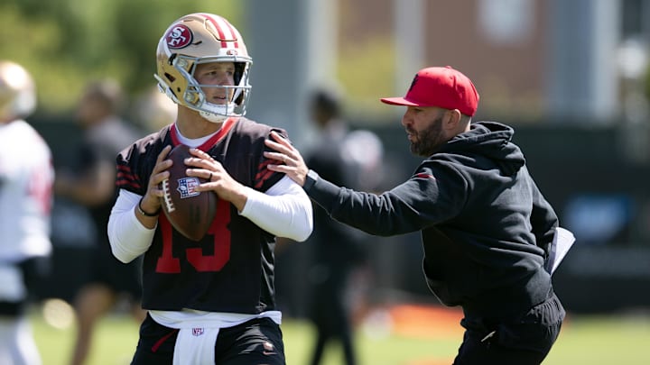 Jun 11, 2025; Santa Clara, CA, USA; San Francisco 49ers quarterbacks coach harasses Brock Purdy (13) in a passing drill during a team OTA at Levi's Stadium. Mandatory Credit: D. Ross Cameron-Imagn Images Jun 11, 2025; Santa Clara, CA, USA; San Francisco 49ers quarterbacks coach harasses Brock Purdy (13) in a passing drill during a team OTA at Levi's Stadium. Mandatory Credit: D. Ross Cameron-Imagn Images