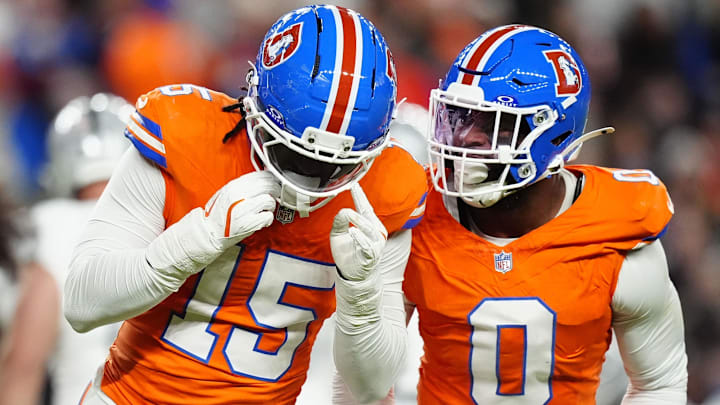 Nov 6, 2025; Denver, Colorado, USA; Denver Broncos linebacker Nik Bonitto (15) and linebacker Jonathon Cooper (0) react during the first half at Empower Field at Mile High. 