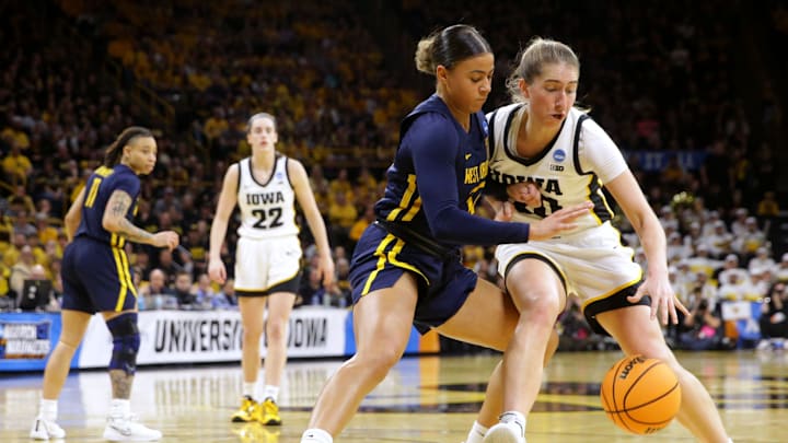 Iowa’s Kate Martin (20) drives to the basket as West Virginia’s Kyah Watson (32) defends in a NCAA Tournament round of 32 game Monday, March 25, 2024 at Carver-Hawkeye Arena.