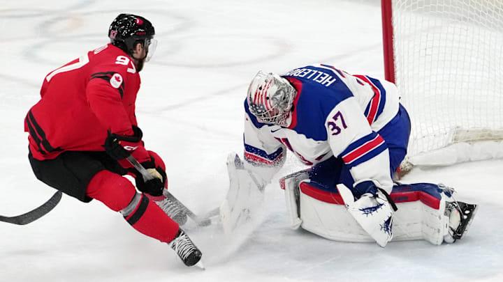 Feb 22, 2026; Milan, Italy; Connor McDavid of Canada shoots the puck against Connor Hellebuyck of the United States during the men's ice hockey gold medal game during the Milano Cortina 2026 Olympic Winter Games at Milano Santagiulia Ice Hockey Arena. Mandatory Credit: James Lang-Imagn Images