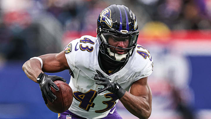 Dec 15, 2024; East Rutherford, New Jersey, USA; Baltimore Ravens running back Justice Hill (43) catches a touchdown pass during the second half against the New York Giants at MetLife Stadium. Mandatory Credit: Vincent Carchietta-Imagn Images