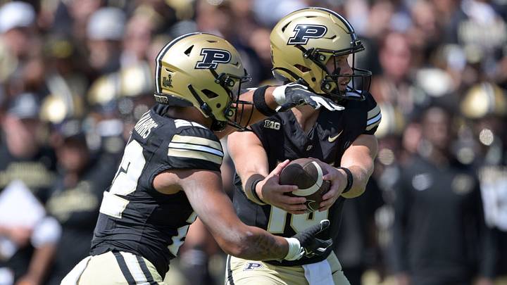 Aug 30, 2025; West Lafayette, Indiana, USA; Purdue quarterback Ryan Browne hands the ball off to running back Antonio Harris. Aug 30, 2025; West Lafayette, Indiana, USA; Purdue quarterback Ryan Browne hands the ball off to running back Antonio Harris.