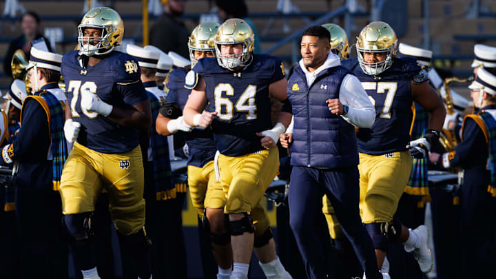Notre Dame head coach Marcus Freeman takes the field with his players before a NCAA football game against Syracuse at Notre Dame Stadium on Saturday, Nov. 22, 2025, in South Bend.