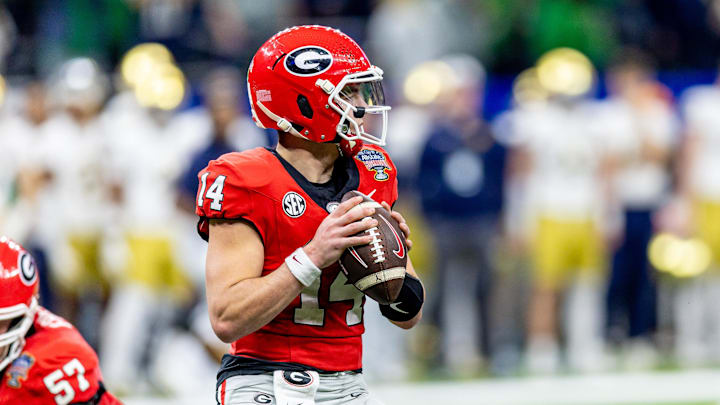 Jan 2, 2025; New Orleans, LA, USA;  Georgia Bulldogs quarterback Gunner Stockton (14) drops back to pass against the Notre Dame Fighting Irish during the first half at Caesars Superdome. Mandatory Credit: Stephen Lew-Imagn Images