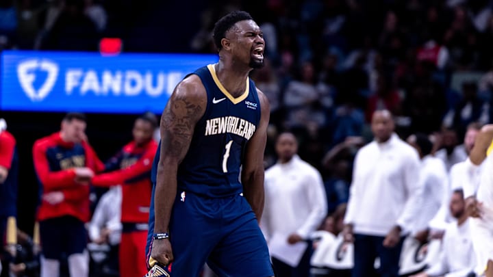 Jan 17, 2025; New Orleans, Louisiana, USA; New Orleans Pelicans forward Zion Williamson (1) reacts to dunking the ball through the arm of Utah Jazz forward Drew Eubanks (15) during the second half at Smoothie King Center.