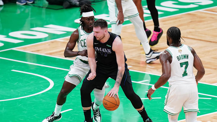 Jun 6, 2024; Boston, Massachusetts, USA; Dallas Mavericks guard Luka Doncic (77) controls the ball against Boston Celtics guard Jrue Holiday (4) in the second quarter during game one of the 2024 NBA Finals at TD Garden. Mandatory Credit: David Butler II-USA TODAY Sports
