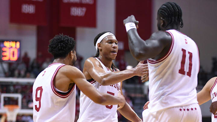Indiana Hoosiers guard Kanaan Carlyle (9), forward Malik Reneau (5) and center Oumar Ballo (11) celebrate after a play during the first half against the Minnesota Golden Gophers at Simon Skjodt Assembly Hall.