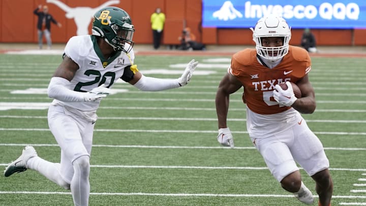 Texas Longhorns running back Bijan Robinson runs past Baylor Bears defensive back Devin Lemear during the second half