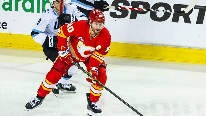 Apr 12, 2026; Calgary, Alberta, CAN; Calgary Flames left wing Blake Coleman (20) controls the puck against the Utah Mammoth during the second period at Scotiabank Saddledome. Mandatory Credit: Sergei Belski-Imagn Images