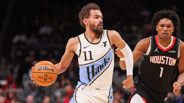 Jan 28, 2025; Atlanta, Georgia, USA; Atlanta Hawks guard Trae Young (11) is defended by Houston Rockets forward Amen Thompson (1) in the first quarter at State Farm Arena. Mandatory Credit: Brett Davis-Imagn Images
