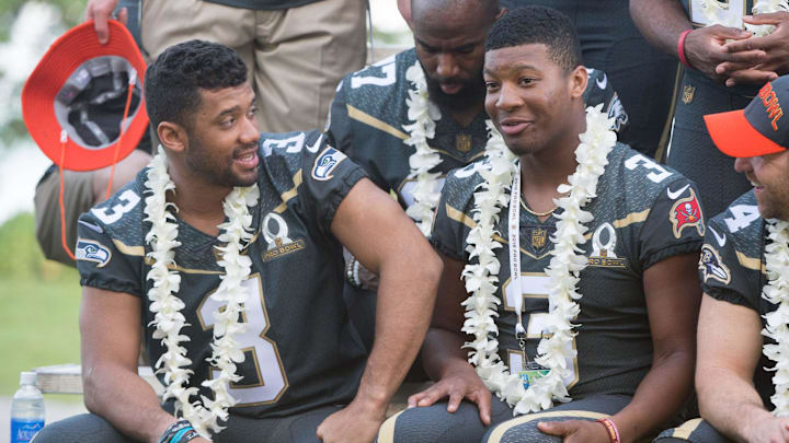 January 29, 2016; Kahuku, HI, USA; Team Irvin quarterback Russell Wilson of the Seattle Seahawks (3, left) talks to Team Irvin quarterback Jameis Winston of the Tampa Bay Buccaneers (3, right) during 2016 Pro Bowl photo day at Turtle Bay Resort. Mandatory Credit: Kyle Terada-Imagn Images