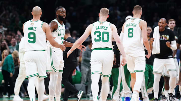 Jun 6, 2024; Boston, Massachusetts, USA; Boston Celtics forward Sam Hauser (30) and guard Jaylen Brown (7) react in the first quarter against the Dallas Mavericks during game one of the 2024 NBA Finals at TD Garden. Mandatory Credit: David Butler II-Imagn Images