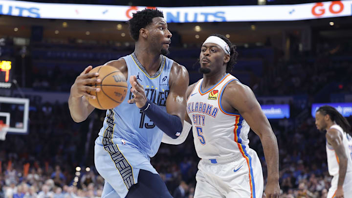 Mar 27, 2025; Oklahoma City, Oklahoma, USA; Memphis Grizzlies forward Jaren Jackson Jr. (13) moves the ball down the court beside Oklahoma City Thunder guard Luguentz Dort (5) during the second half at Paycom Center. Mandatory Credit: Alonzo Adams-Imagn Images