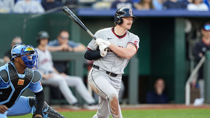 Mar 27, 2025; Kansas City, Missouri, USA; Cleveland Guardians designated hitter Kyle Manzardo (9) hits an RBI double against the Kansas City Royals during the tenth inning at Kauffman Stadium. Mandatory Credit: Jay Biggerstaff-Imagn Images