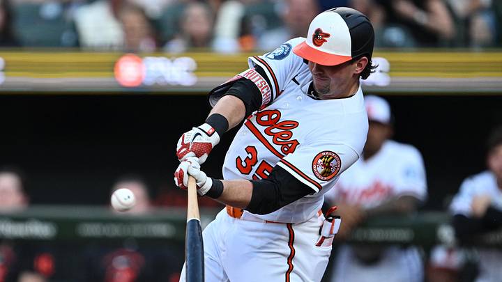 Jun 29, 2026; Baltimore, Maryland, USA;  Baltimore Orioles catcher Adley Rutschman (35) hits a RBI sacrifice fly in the first inning against the Chicago White Sox at Oriole Park at Camden Yards. Mandatory Credit: Jamie Sabau-Imagn Images