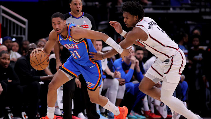 Apr 4, 2025; Houston, Texas, USA; Oklahoma City Thunder guard Aaron Wiggins (21) handles the ball against Houston Rockets guard Amen Thompson (1) during the third quarter at Toyota Center. Mandatory Credit: Erik Williams-Imagn Images