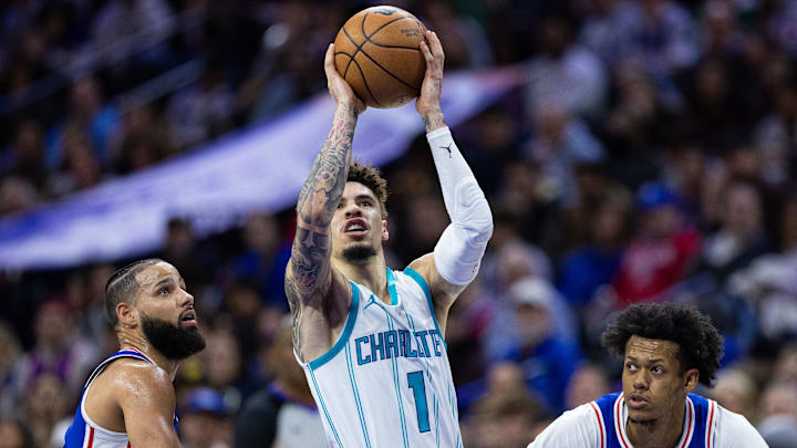 Nov 10, 2024; Philadelphia, Pennsylvania, USA; Charlotte Hornets guard LaMelo Ball (1) drives between Philadelphia 76ers forward Caleb Martin (L) and guard Jeff Dowtin Jr. (R) during the second quarter at Wells Fargo Center. Mandatory Credit: Bill Streicher-Imagn Images Nov 10, 2024; Philadelphia, Pennsylvania, USA; Charlotte Hornets guard LaMelo Ball (1) drives between Philadelphia 76ers forward Caleb Martin (L) and guard Jeff Dowtin Jr. (R) during the second quarter at Wells Fargo Center. Mandatory Credit: Bill Streicher-Imagn Images