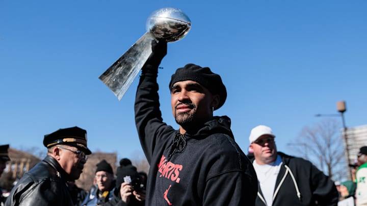 Feb 14, 2025; Philadelphia, PA, USA; Philadelphia Eagles quarterback Jalen Hurts (1) raises the Lombardi Trophy during the Super Bowl LIX championship parade and rally. Mandatory Credit: Caean Couto-Imagn Images