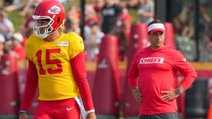 Jul 26, 2024; Kansas City, MO, USA; Kansas City Chiefs quarterback Patrick Mahomes (15) steps to the line as general manager Brett Veach watches in the background during training camp at Missouri Western State University. Mandatory Credit: Denny Medley-Imagn Images