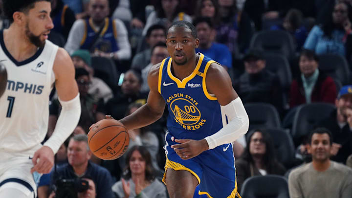 Jan 4, 2025; San Francisco, California, USA;  Golden State Warriors forward Jonathan Kuminga (00) dribbles up court in front of Memphis Grizzlies guard Scotty Pippen Jr. (1) in the second quarter at Chase Center. Mandatory Credit: David Gonzales-Imagn Images