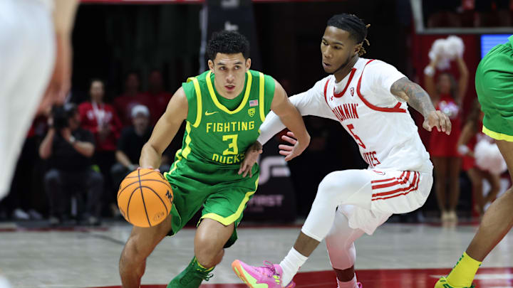 Jan 21, 2024; Salt Lake City, Utah, USA; Oregon Ducks guard Jackson Shelstad (3) drives the ball against a Utah defender.