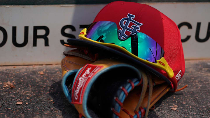 Mar 20, 2018; Jupiter, FL, USA; A St. Louis Cardinals hat with sunglasses sits on a glove in the dugout during a spring training game against the New York Mets at Roger Dean Stadium. Mandatory Credit: Jasen Vinlove-Imagn Images Mar 20, 2018; Jupiter, FL, USA; A St. Louis Cardinals hat with sunglasses sits on a glove in the dugout during a spring training game against the New York Mets at Roger Dean Stadium. Mandatory Credit: Jasen Vinlove-Imagn Images