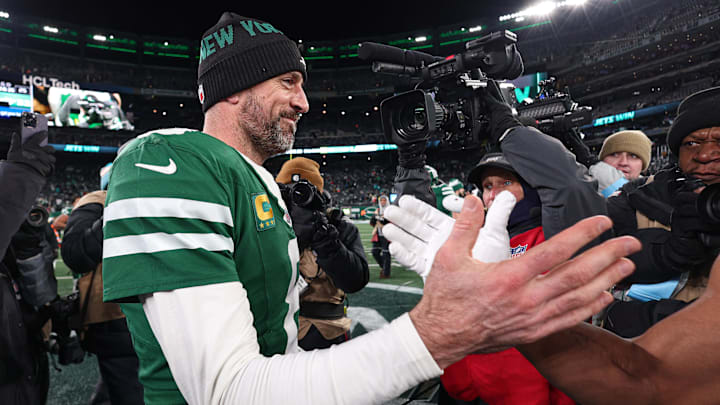 Jan 5, 2025; East Rutherford, New Jersey, USA; New York Jets quarterback Aaron Rodgers (8) shakes hands with a Miami Dolphins player after the game at MetLife Stadium. Mandatory Credit: Vincent Carchietta-Imagn Images